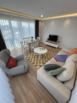a living room with a couch and chairs and a table at Istanbul Bostanci Luxury 2 Bedroom Apartment with Pool in Istanbul