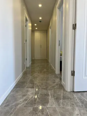 an empty hallway with marble floors and white walls at Istanbul Bostanci Luxury 2 Bedroom Apartment with Pool in Istanbul