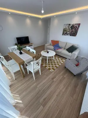 a living room with a couch and a table at Istanbul Bostanci Luxury 2 Bedroom Apartment with Pool in Istanbul