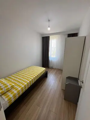 a bedroom with a bed with a yellow checkered blanket at Istanbul Bostanci Luxury 2 Bedroom Apartment with Pool in Istanbul