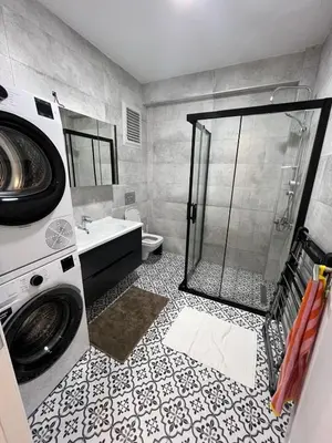 a bathroom with a shower and a washing machine at Istanbul Bostanci Luxury 2 Bedroom Apartment with Pool in Istanbul