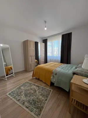 a bedroom with a bed and a table and a mirror at Istanbul Bostanci Luxury 2 Bedroom Apartment with Pool in Istanbul