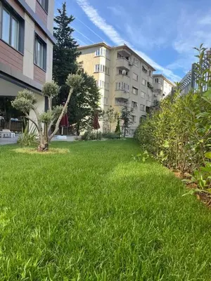 a field of green grass next to some buildings at Istanbul Bostanci Luxury 2 Bedroom Apartment with Pool in Istanbul
