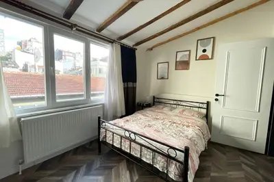 a bedroom with a bed in a room with windows at charming apt with fast WİFİ and AC near Nişantaşi and Taksim#5 in Istanbul
