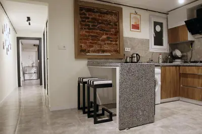 a kitchen with a counter and stools at charming apt with fast WİFİ and AC near Nişantaşi and Taksim#5 in Istanbul
