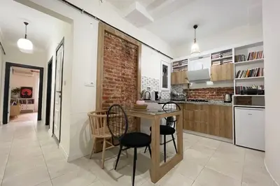 a kitchen with a table and chairs and a brick wall at balcony 2BR apt with 2toilet and 2bath near to nişantaşi #3 in Istanbul