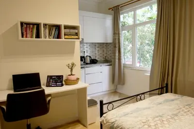 a bedroom with a bed and a desk with a laptop at balcony 2BR apt with 2toilet and 2bath near to nişantaşi #3 in Istanbul