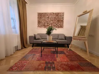a living room with a couch and a table and a mirror at balcony 2BR apt near to nişantaşi #2 in Istanbul