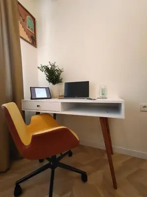 a white desk with a chair and a laptop on it at balcony 2BR apt near to nişantaşi #2 in Istanbul