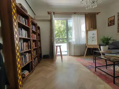 a living room with book shelves filled with books at balcony 2BR apt near to nişantaşi #2 in Istanbul