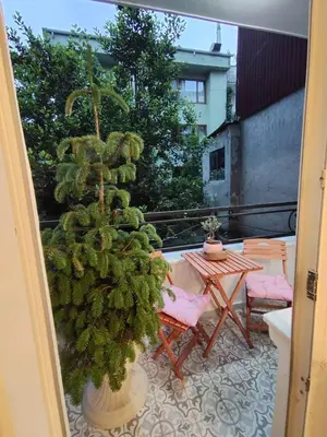 a christmas tree on a patio with a table and chairs at balcony 2BR apt near to nişantaşi #2 in Istanbul