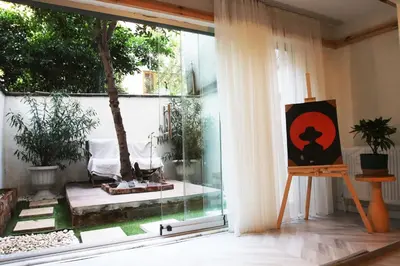 a painting on a stand in a room with a window at baesment 2BR apt with 2toilet and 2bath 8min to metro #1 in Istanbul