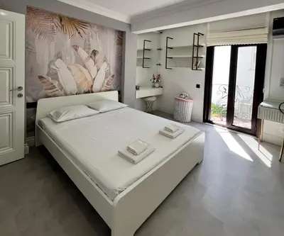 a bedroom with a large white bed with towels on it at Cloud Nine by Alara - Luxury Private Pool and Garden Villa in Beylikduzu