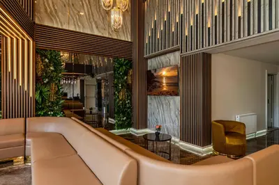a lobby with a couch and a chair at Airport Waves Hotel in Arnavutköy