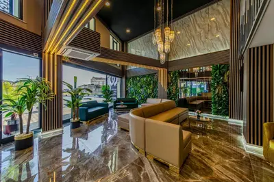 a living room with a couch and some plants at Airport Waves Hotel in Arnavutköy
