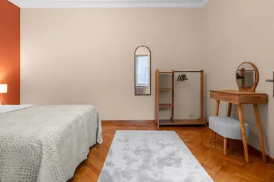 a bedroom with a bed and a table and a mirror at Elegant 2BR Haven with Magnificent Bosphorus View in Istanbul