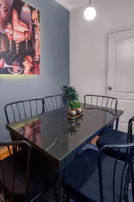 a dining room table with chairs and a plant on it at Fully Equipped & Modern Designed Spectacular 3BR in Istanbul