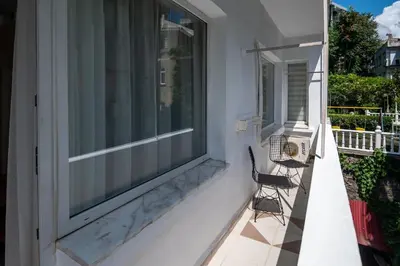 a bench on a porch with a large window at Fully Equipped & Modern Designed Spectacular 3BR in Istanbul