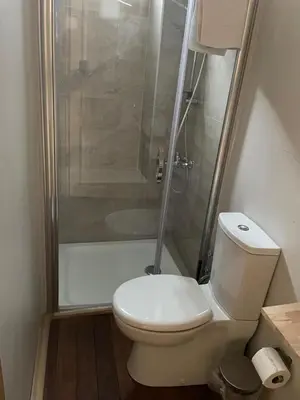 a small bathroom with a toilet and a shower at Pink Home 4 in Istanbul