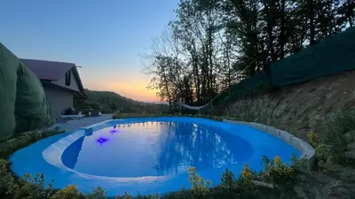 a large blue swimming pool in a backyard at Kocaeli Başiskele Doğayla İç İçe Özel Havuzlu Tatil Evi in Bahçecik