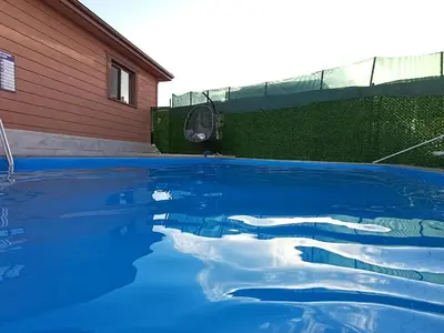 a pool of blue water in front of a house at Kandıra villam in Duraklı