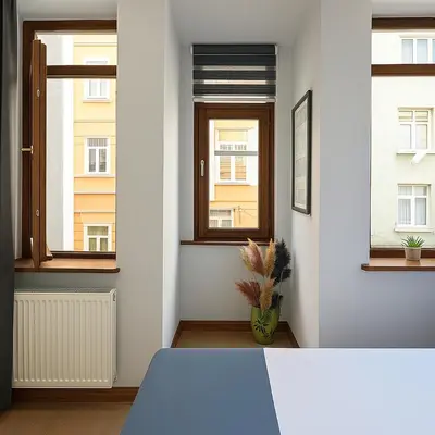 a room with two windows and a blue table at PeraHomes in Istanbul