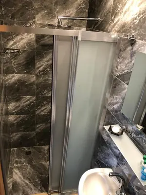 a bathroom with a stainless steel shower with a sink at Ottoman's Pearl Hotel in Istanbul