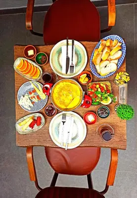 a wooden table with plates of food on it at Ottoman's Pearl Hotel in Istanbul