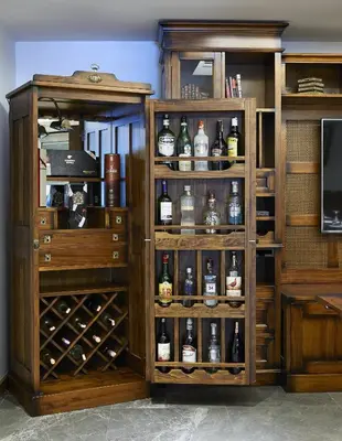 a book shelf with bottles of alcohol in it at Milport Hotel Levent Istanbul in Istanbul