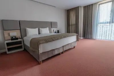 a bedroom with a large bed and a large window at Berjer Boutique Hotel & Spa in Istanbul