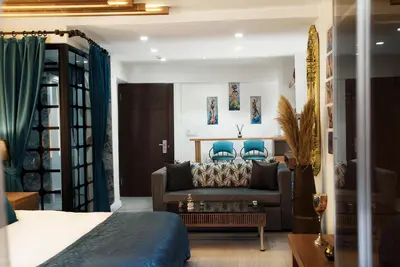 a living room with a couch and blue chairs at Taksim Yazıcı Residence in Istanbul