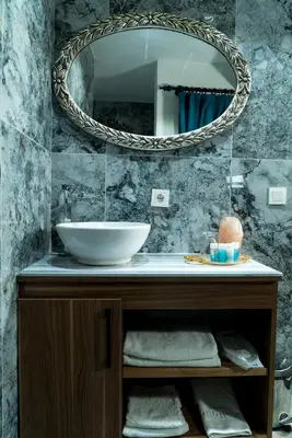 a bathroom with a sink and a mirror at Taksim Yazıcı Residence in Istanbul