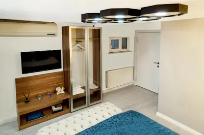 a living room with a couch and a tv at Taksim Yazıcı Residence in Istanbul