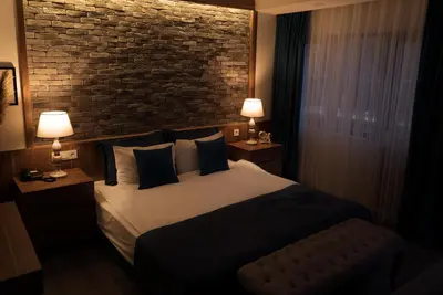 a hotel room with a bed and a brick wall at Taksim Yazıcı Residence in Istanbul