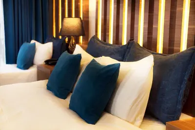 a bedroom with two beds with blue and white pillows at Taksim Yazıcı Residence in Istanbul