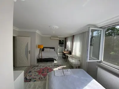 a bedroom with a bed and a room with a window at forest villa, breakfast hotel, 6 minutes from Istanbul airport in Arnavutköy