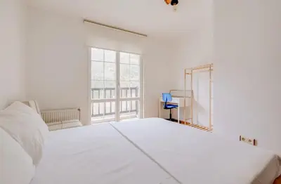 a white bedroom with a large bed and a window at Villa Sapanca in Sapanca