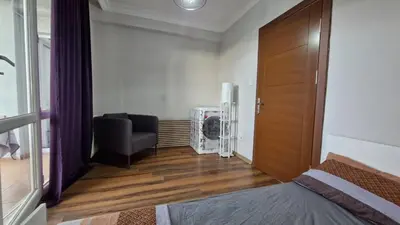a room with a bed and a chair and a door at Sabina gokcene 5 dk in Istanbul