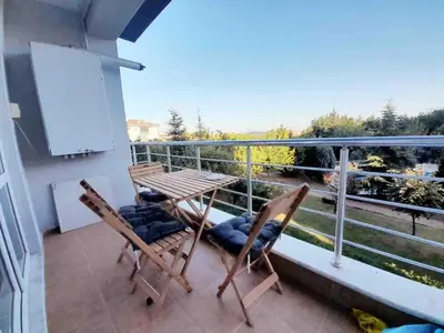 a balcony with two chairs and a table on a balcony at Sabina gokcene 5 dk in Istanbul