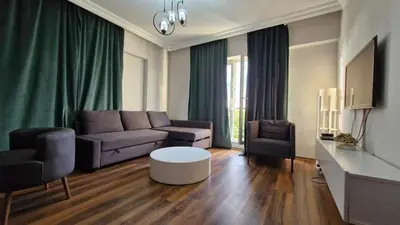 a living room with a couch and a table at Sabina gokcene 5 dk in Istanbul