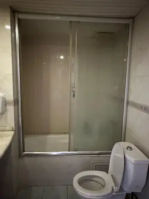 a bathroom with a shower and a toilet and a tub at Butik Apart in Tekirdag