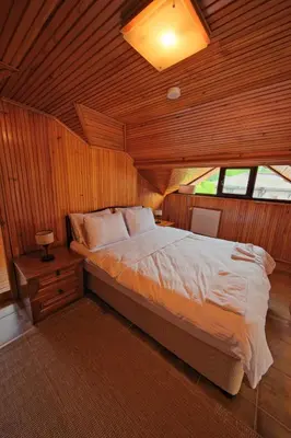 a bedroom with a bed in a wooden room at Kiwii Sapanca in Sapanca