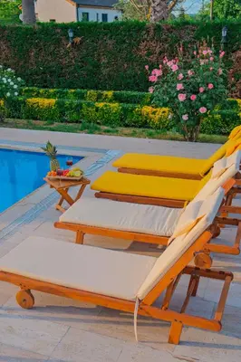 three lounge chairs sitting next to a swimming pool at Kiwii Sapanca in Sapanca
