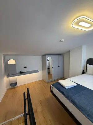 a bedroom with a large bed with a blue blanket at Nest Ortaköy in Istanbul