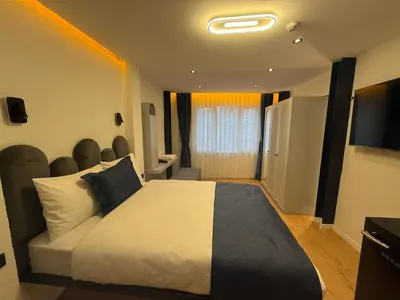 a hotel room with a bed and a television at Nest Ortaköy in Istanbul