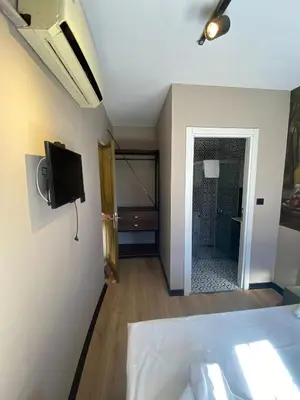 a bedroom with a bed and a tv on a wall at Nest Ortaköy in Istanbul