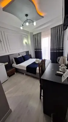 a bedroom with a bed and a desk in it at RAMOS İSTANBUL OLD CİTY CENTEr in Istanbul