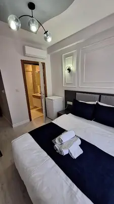 a bedroom with a large bed with towels on it at RAMOS İSTANBUL OLD CİTY CENTEr in Istanbul