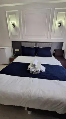 a bedroom with a large white bed with two pairs of goggles at RAMOS İSTANBUL OLD CİTY CENTEr in Istanbul