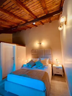 a bedroom with a large bed with blue pillows at Niceland İznik